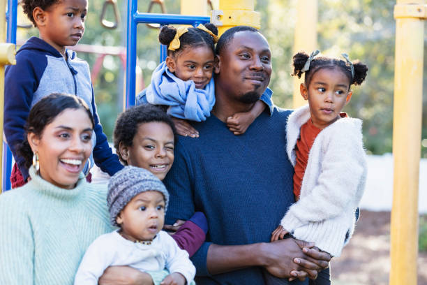istock Multi-racial family with five children on playground 1305651531