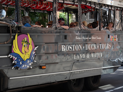 Boston, USA - June 15, 2019: Image of an amphibious vehicle from Boston Duck Tours driving around tourists in downtown Boston.