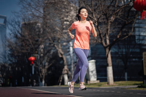 istock Female running in the city 1305654134
