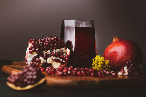 Pomegranate split open with pips on a grunge surface with copy space