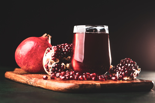 Fresh  pomegranate juice on dark background