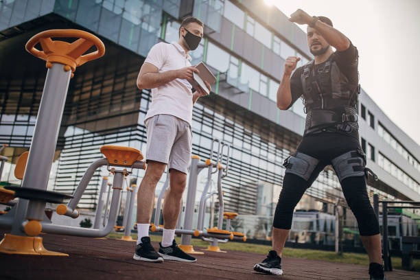istock Man exercising in electrical muscular stimulation suit outdoors 1305657663