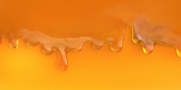 Dripping honey. Golden yellow syrup. Oil splashes