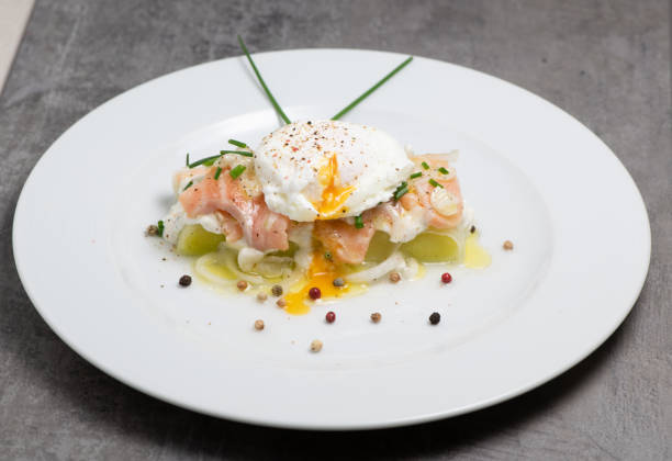 istock Poached egg on a bed of leek and marinated fresh salmon, chive sauce 1305660467