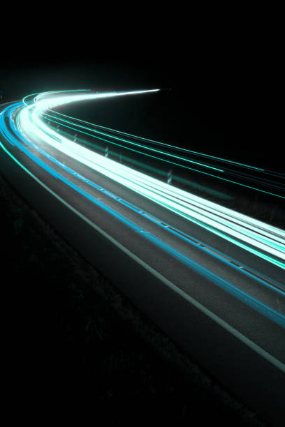 istock blue car lights at night. long exposure 1305660539