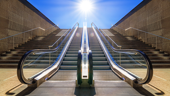 modern escalator against a sunny sky