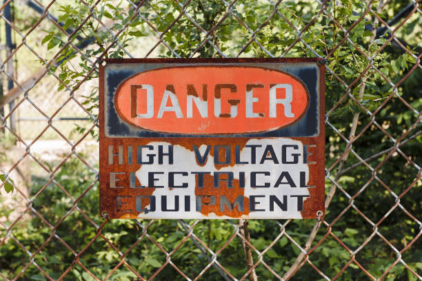 istock Old and worn Danger High Voltage sign on a chain link fence 1305663627