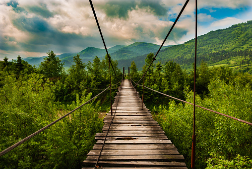 Suspension bridge over the mountain river Striy in the Carpathian National Park