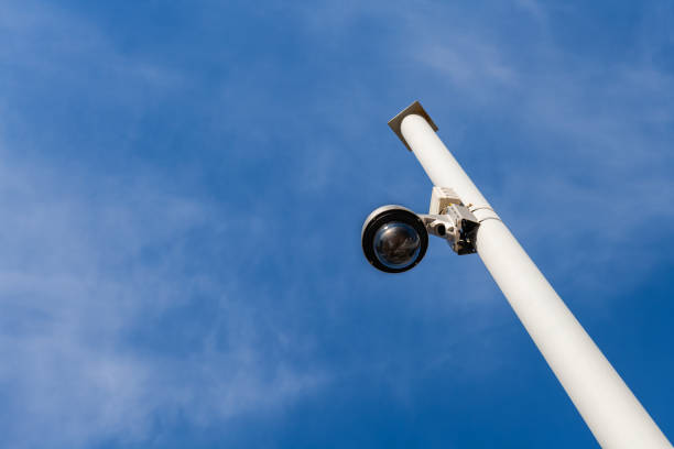istock Street surveillance camera on a white metal pole 1305667673