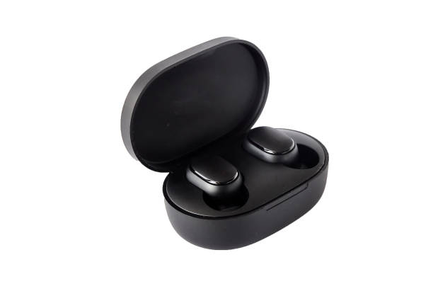 istock Wireless headphones on a white background. Close-up. Bluetooth headset in charging case. 1305670067