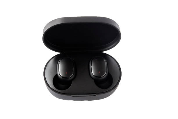 istock Wireless headphones on a white background. Close-up. Bluetooth headset in charging case. 1305670069