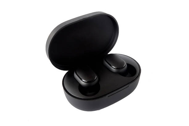 istock Wireless headphones on a white background. Close-up. Bluetooth headset in charging case. 1305670080