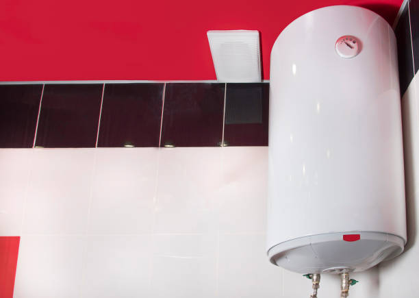 istock Tank electric water heater on white and red tiled wall. Copy space for text 1305670262