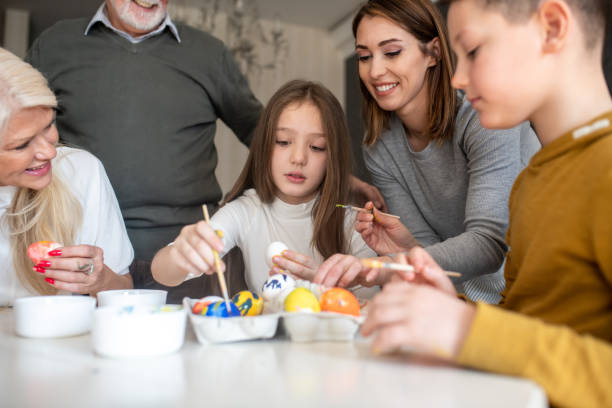 istock Family gathered to paint Easter eggs. 1305671324