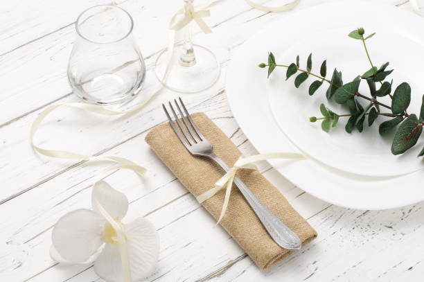 istock Spring romantic table setting with white flowers on white wooden table 1305671369