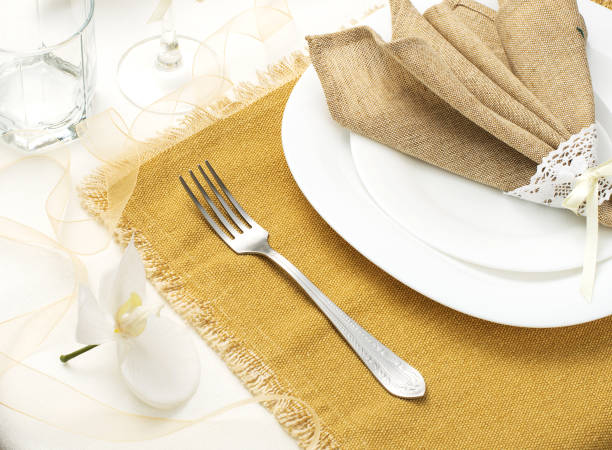 istock Festive table setting with plates, cutlery, flowers and a napkin, Spring table setting 1305671376