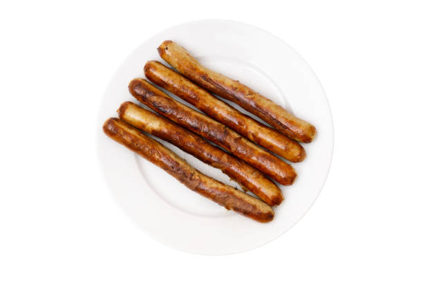 istock Grilled german sausages on a white plate isolated on white 1305674499
