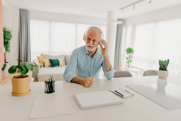 istock Happy senior man listening music 1305674717