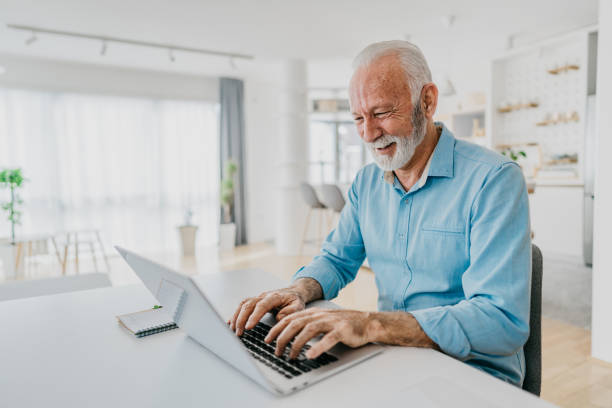 istock Senior man shopping online using a credit card 1305674812