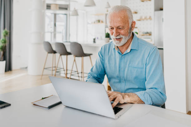 istock Senior man shopping online using a credit card 1305675476