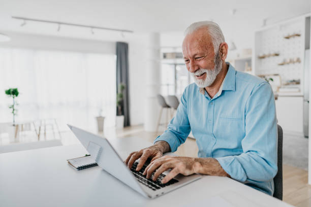 istock Senior man shopping online using a credit card 1305675550
