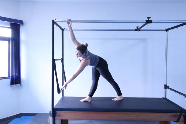 istock woman doing pilates physical exercises 1305679577