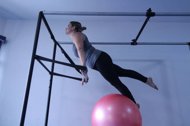 istock woman doing pilates physical exercises 1305679644