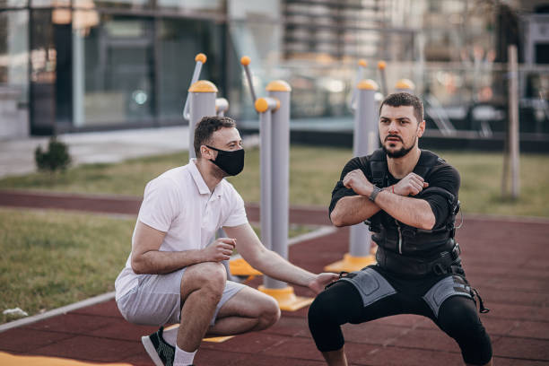istock Man exercising in electrical muscular stimulation suit outdoors 1305680457