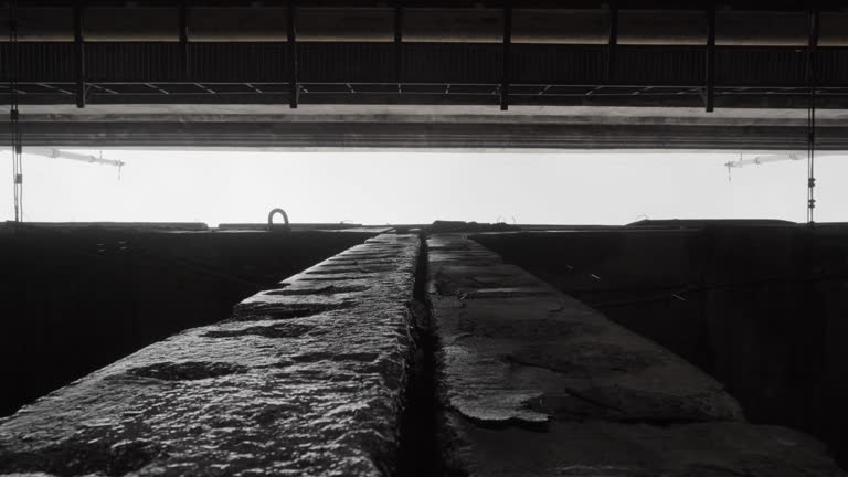 Old damaged concrete structures of the bridge support or overpass of the overpass from which water drips