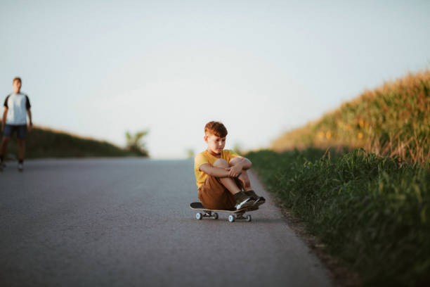 istock Young boy sitting on board, resting. 1305681501