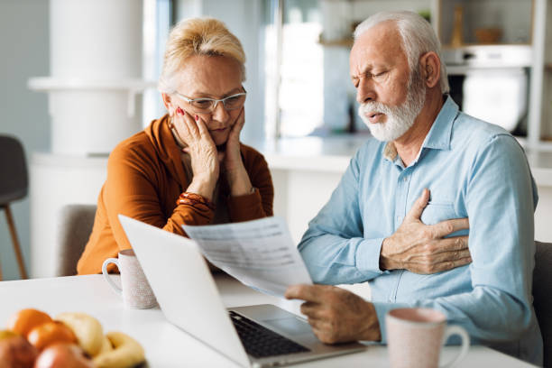 istock Frustrated mature couple having problems with paying their bills over Internet 1305682738