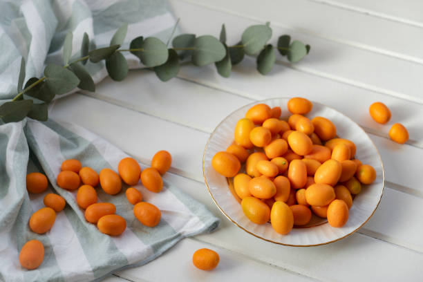 Kumquats Kumquats on wood kumquat stock pictures, royalty-free photos & images