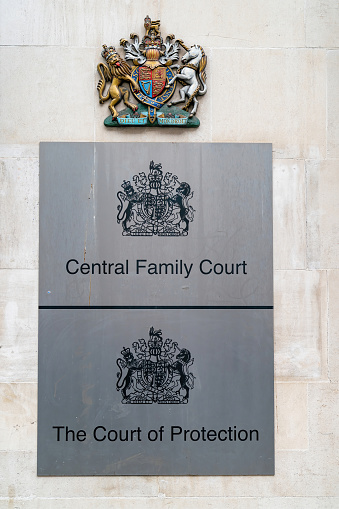 This picture shows the signs outside the Central Family Court in London, which is also known as the Principal Registry of the Family Division of the High Court and The Court of Protection in Holborn, London.  To most lawyers in England this building is known as First Avenue House.  This image also shows the famous crest above all Courts in England which reads \