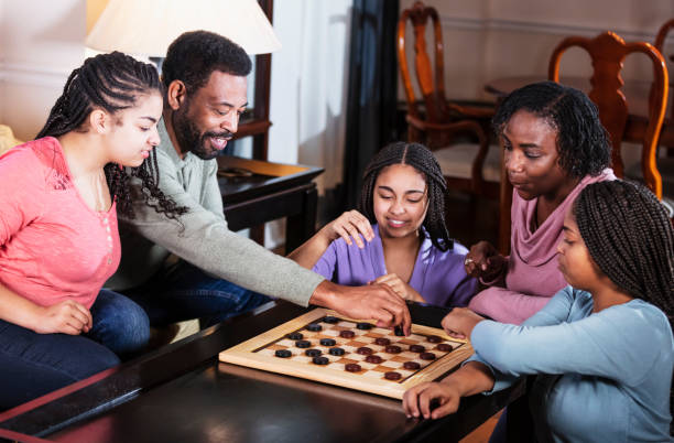 istock African-American family at home playing checkers 1305684119