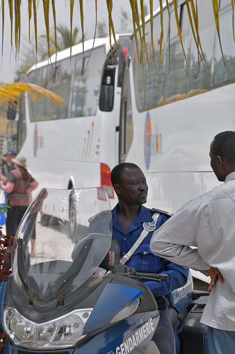Dakar, Senegal - May 21,2012 : A Senegalese Gendarmerie on his motorcycle talking with one of the tour bus drivers on a cruise ship tour