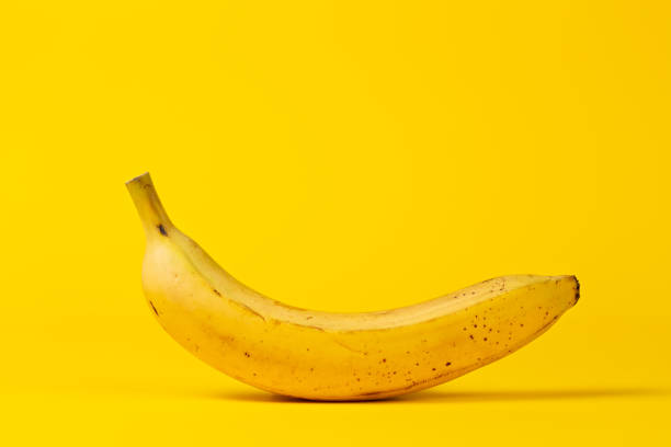 istock Yellow banana on a yellow background. Copy space 1305685328