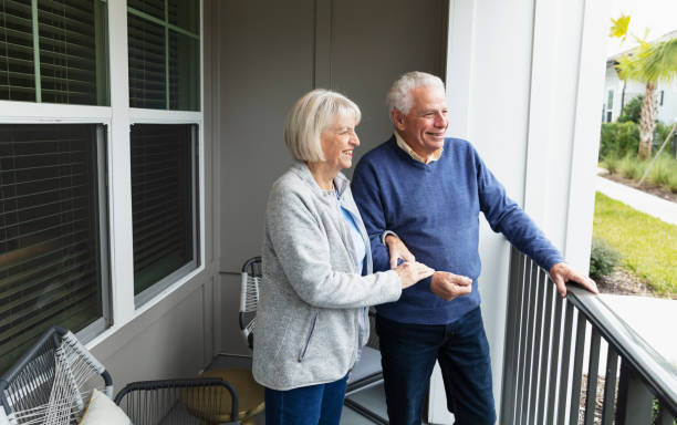 istock Senior couple on apartment balcony looking at view 1305686216