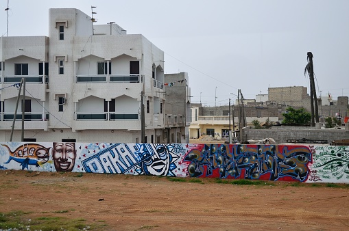 dakar, Senegal - May 21,2012 : Graffiti on a wall surrounding a residential area and construction site in a suburb of Dakar
