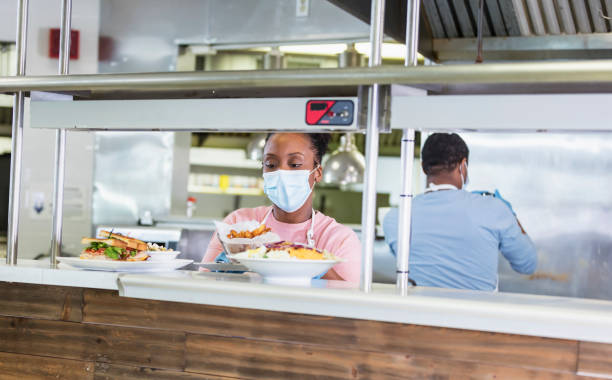 istock Restaurant cook  with finished order, wearing face mask 1305686552