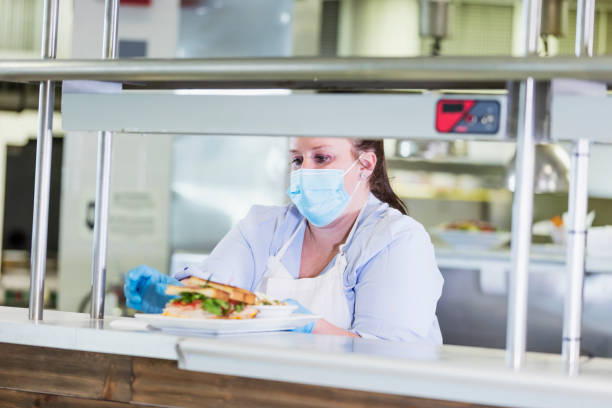 istock Restaurant cook  with finished order, wearing face mask 1305686558