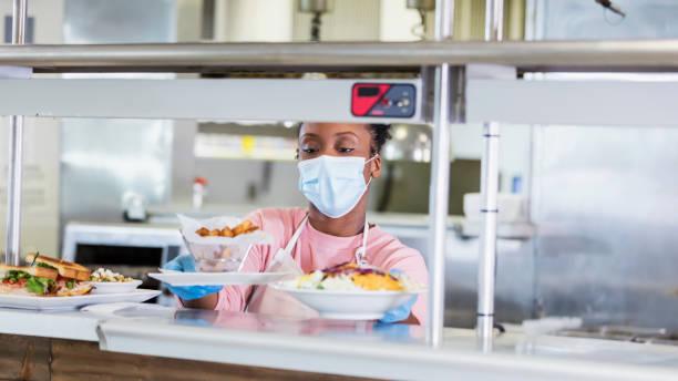 istock Restaurant cook  with finished order, wearing face mask 1305686567