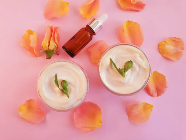 istock cream cosmetic rose flower on colored background 1305686918