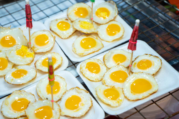 street food in Thailand. Fried eggs. Scrambled eggs for take away street food in Thailand. Fried eggs. Scrambled eggs for take away. quail egg stock pictures, royalty-free photos & images