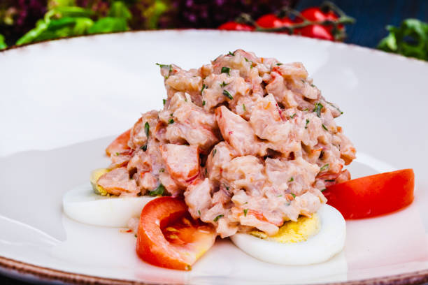 istock Lobster salad with egg and tomato on white plate. 1305688098