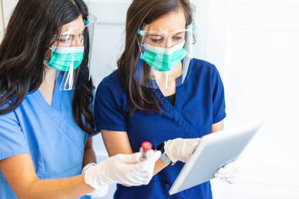 istock Two Female Millennial Medical Science Professionals Experimenting and Documenting Results Photo Series 1305688969