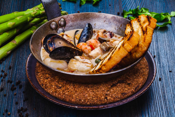 istock Mixed seafood saute served with toasted bread in a pan 1305688991