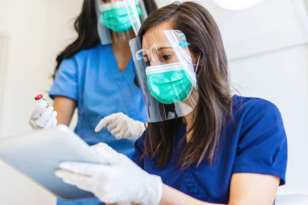 istock Two Female Millennial Medical Science Professionals Experimenting and Documenting Results Photo Series 1305689001