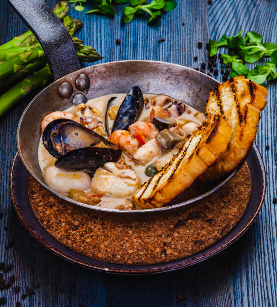 istock Mixed seafood saute served with toasted bread in a pan 1305689011