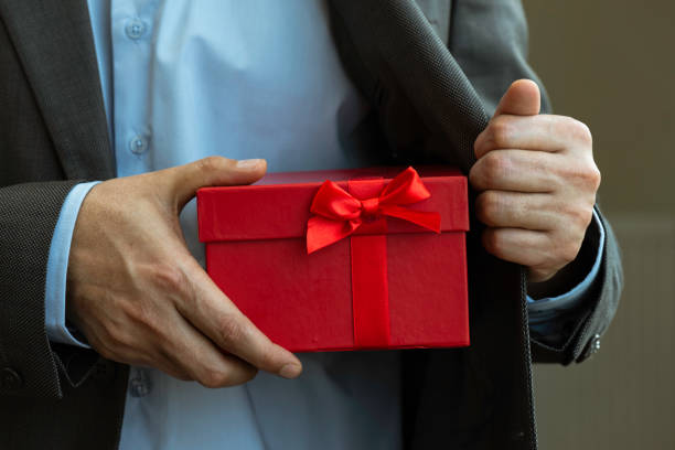 istock Businessman giving Gift Box 1305690120
