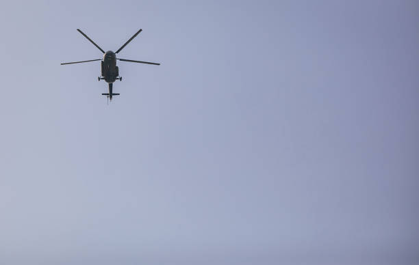 istock Helicopter in the blue sky 1305690329